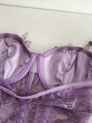 Purple lace bustier top with butterfly appliques and bow detail.