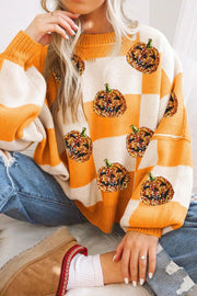 Checkerboard pumpkin appliqué knit sweater in tangerine and cream with sequin detail.