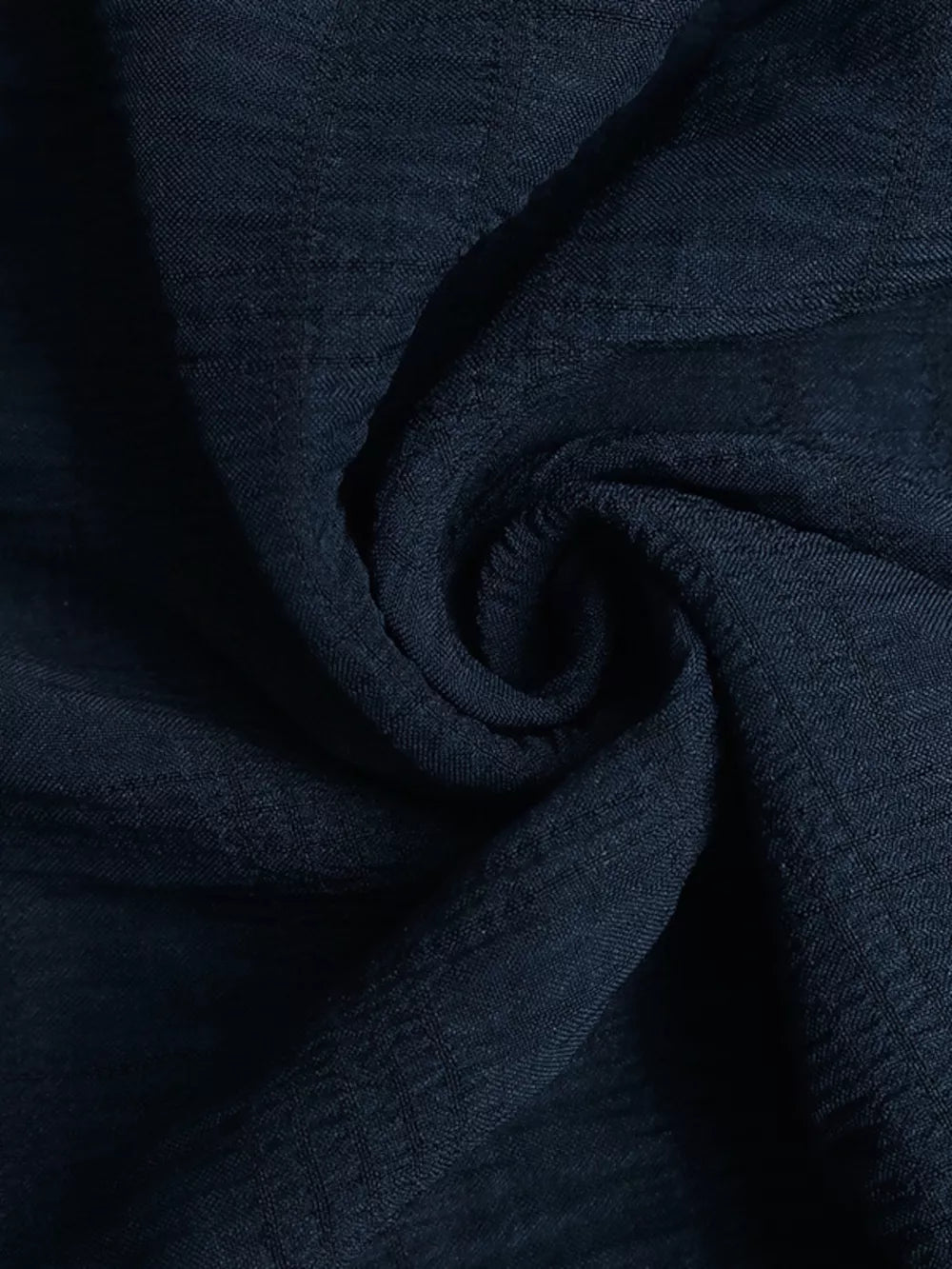 Navy ruched halter midi dress fabric with subtle texture detail.