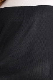 Black waffle knit blouse with a white neckline detail