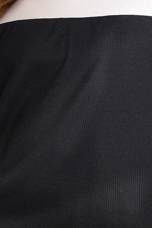 Black waffle knit blouse with a white neckline detail