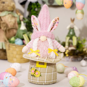 Easter gnome with pink bunny ears and beard, wearing striped sleeves and yellow bows.