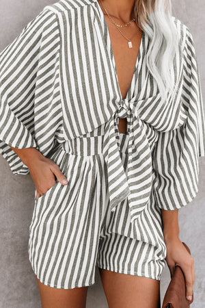 Striped tie-front kimono jumpsuit in dark gray with wide sleeves and a tie detail.