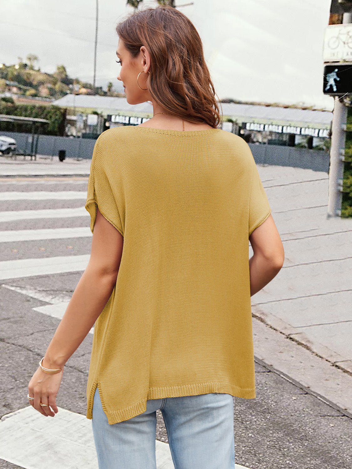 Mustard knit tee with cap sleeves, slit hem, and a wide neckline.
