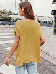 Mustard knit tee with cap sleeves, slit hem, and a wide neckline.