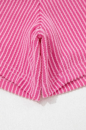 Pink ribbed pajama shorts with contrasting stripe detail and side slits.