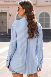 Oversized light blue striped oxford shirt with buttoned cuffs and a relaxed fit.