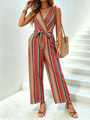 Striped wide-leg jumpsuit with tie waist, V-neck, tie shoulders, and wrap closure in orange and red stripes.