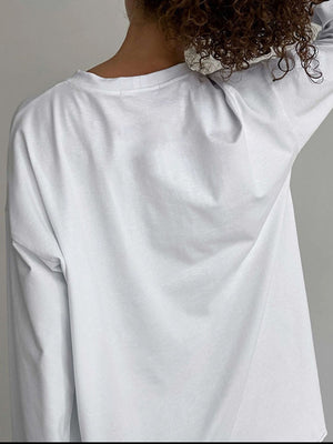 Oversized white cotton jersey long sleeve top with crew neck, shown from the back.