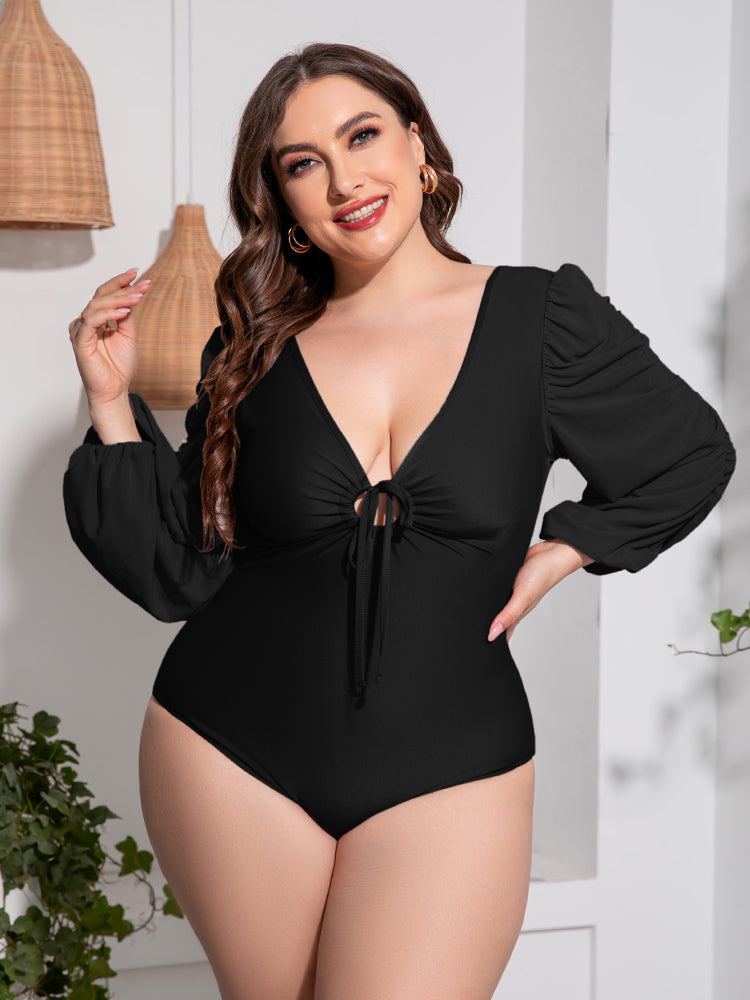 Black one-piece swimsuit with tie-front neckline and ruched balloon sleeves.