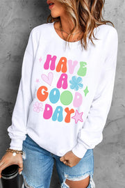 White crewneck sweatshirt with colorful "Have A Good Day" graphic and playful icons.