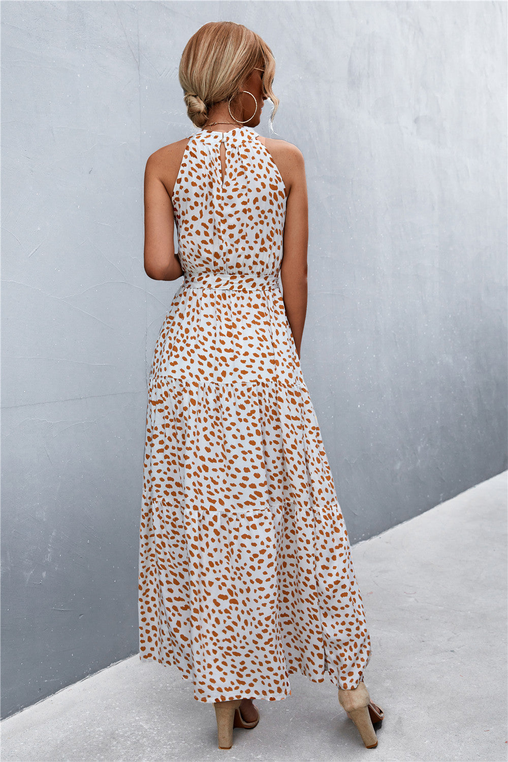 Maxi dress with halter neckline and white with orange spot print.