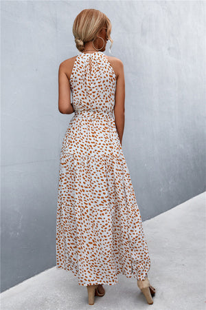Maxi dress with halter neckline and white with orange spot print.