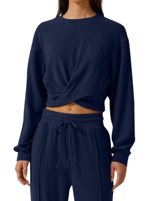 Dark blue cropped twist-front top and relaxed drawstring pants set.