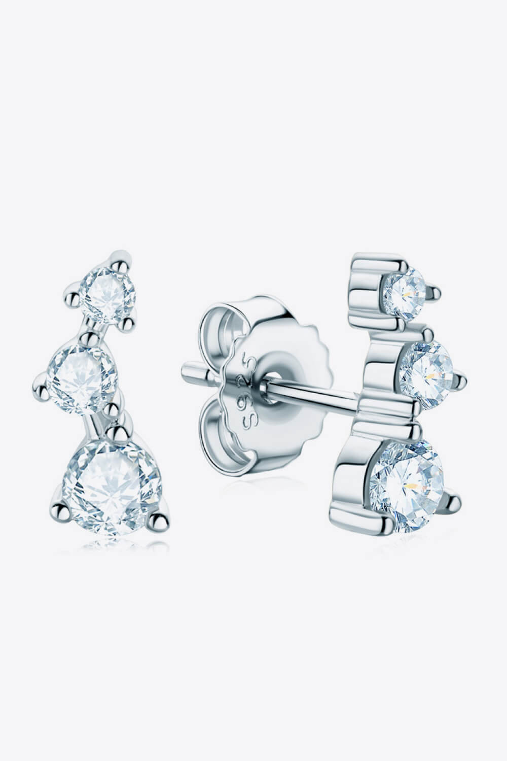 Silver cluster stud earrings with three round moissanite stones in an ascending design.
