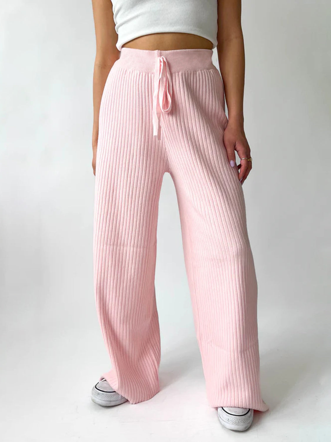 Blush pink ribbed knit palazzo trousers with drawstring waist, wide leg