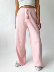 Blush pink ribbed knit palazzo trousers with drawstring waist, wide leg
