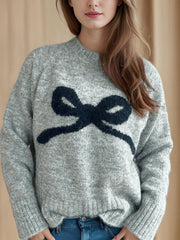 Gray knit sweater with a dark gray bow intarsia design and crew neck.
