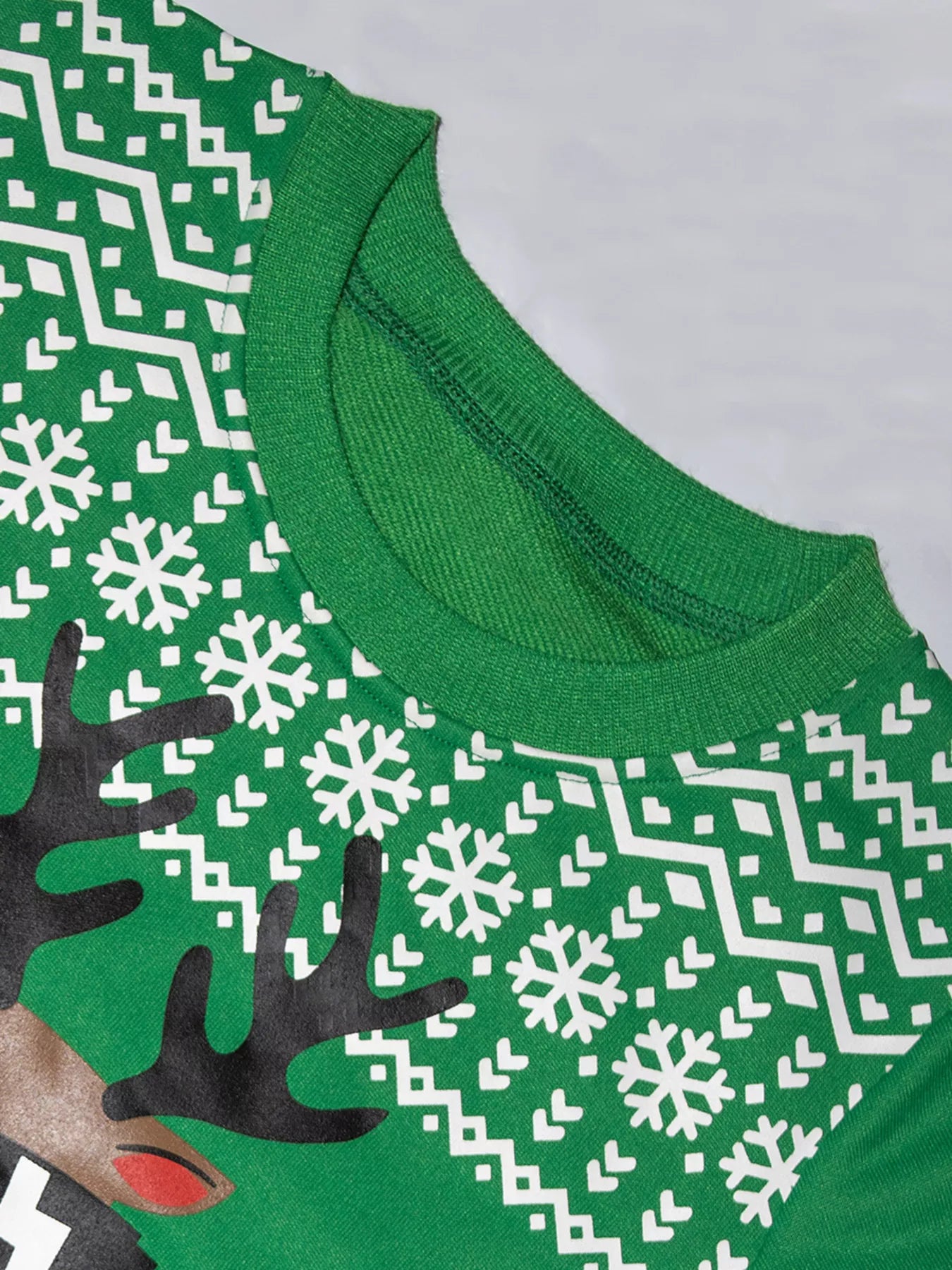 Festive green baby sweatshirt with reindeer and snowflake print.