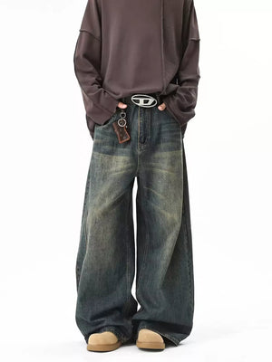 Vintage wash oversized blue cotton jeans with a baggy fit and belted waist.
