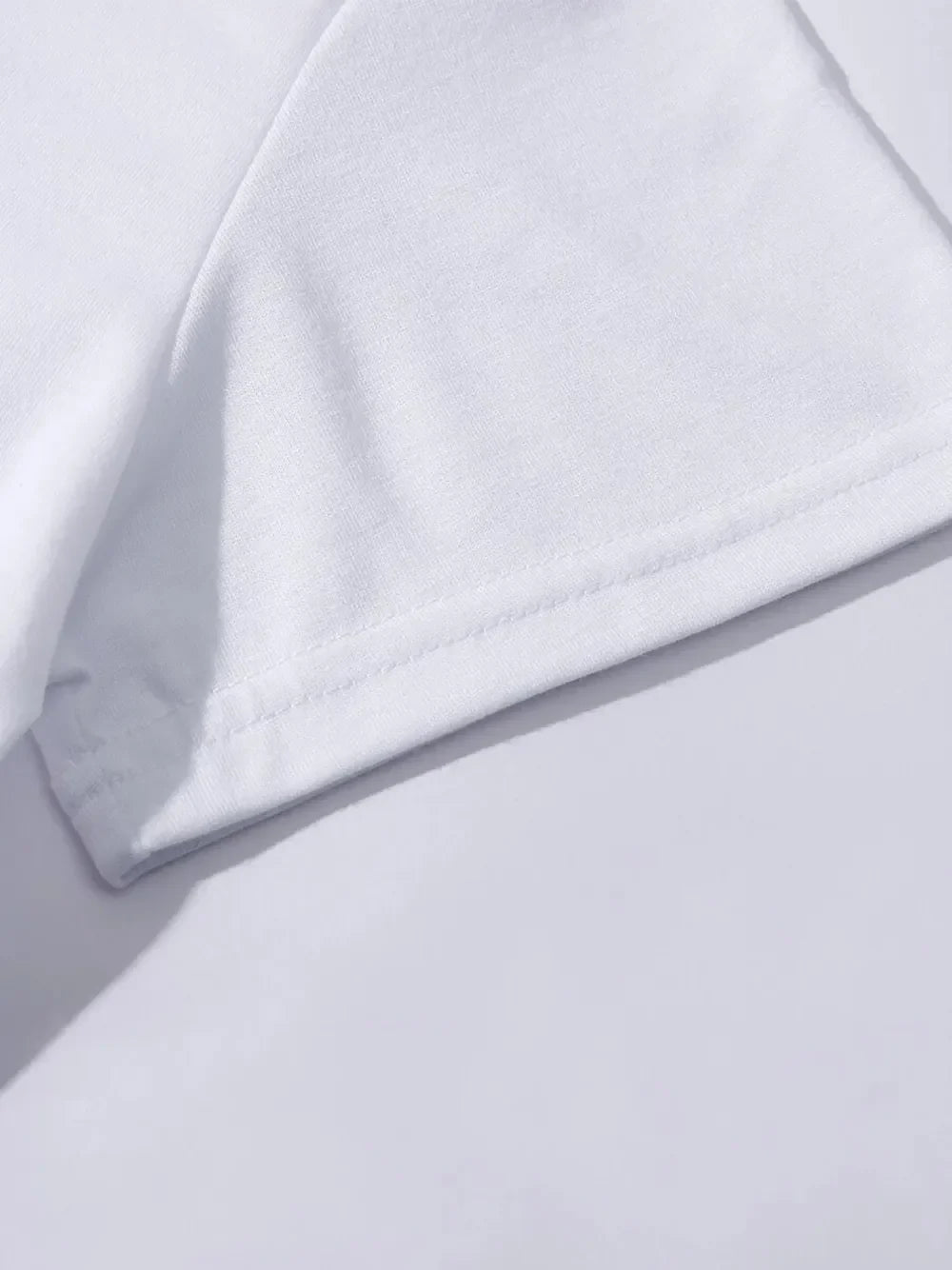 White t-shirt with double-stitched hem and sleeve detail.