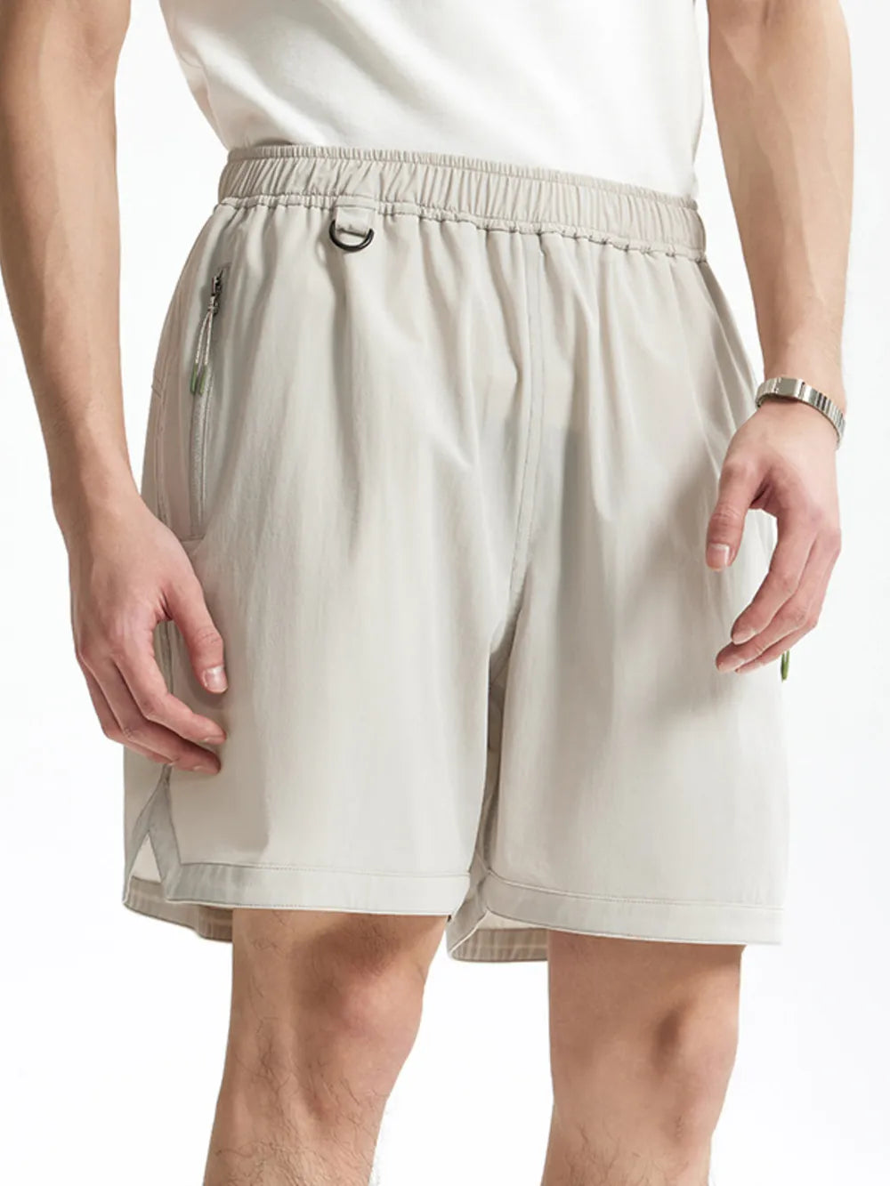 Light gray men's bermuda shorts with elastic waist, d-ring, and zippered pocket.