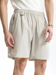 Light gray men's bermuda shorts with elastic waist, d-ring, and zippered pocket.