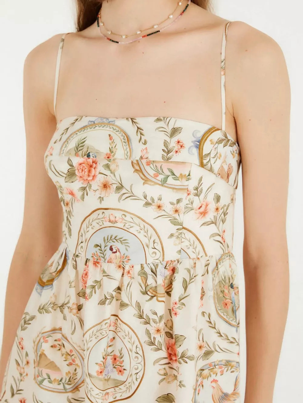 Vintage floral midi dress with spaghetti straps and a charming print of birds and flowers.