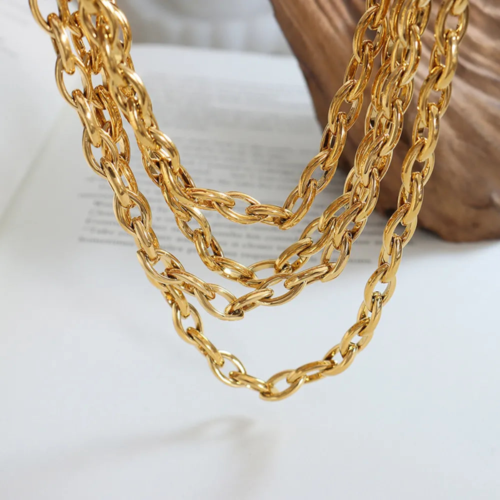 Chunky gold-tone oval link necklace with multiple strands.