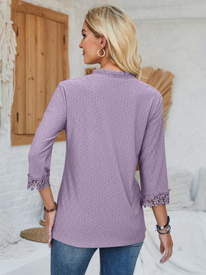 Lavender eyelet blouse with 3/4 sleeves and lace trim cuffs.