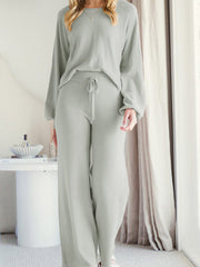 Light gray acrylic loungewear set with wide-leg pants and a crewneck sweater.