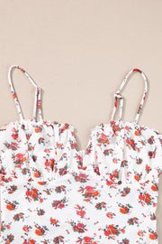 White floral bustier camisole with ruffle trim and adjustable straps.
