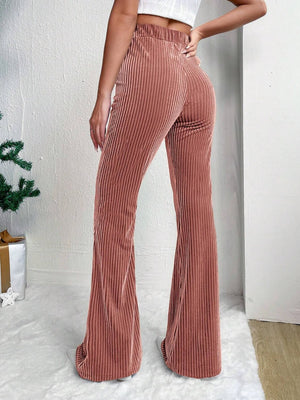 Textured corduroy bell bottom trousers in dusty pink with a high waist.