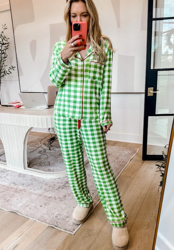 Light green gingham pajama set with red trim, collared long sleeve top and pants.