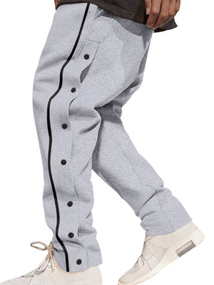Grey track pants with black snap buttons down the side and black piping.
