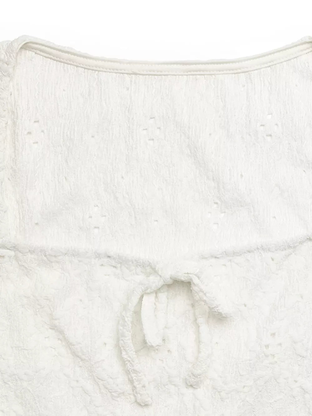 White eyelet lace crop t-shirt with a front tie bow detail.
