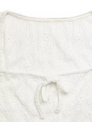 White eyelet lace crop t-shirt with a front tie bow detail.