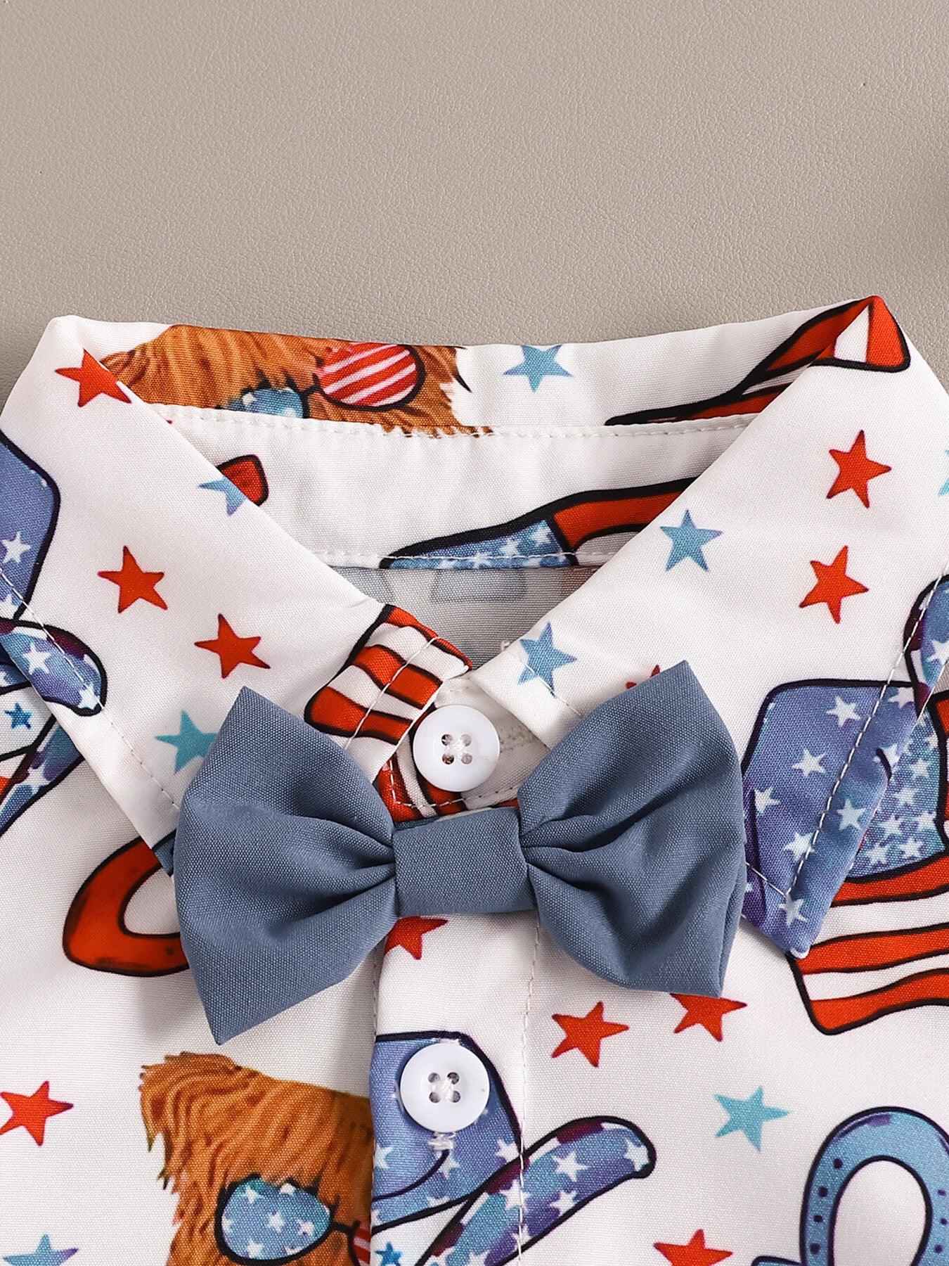 Toddler patriotic print shirt with attached blue bow tie and stars.