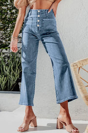 Light blue denim button-front cropped wide-leg jeans with utility pockets.