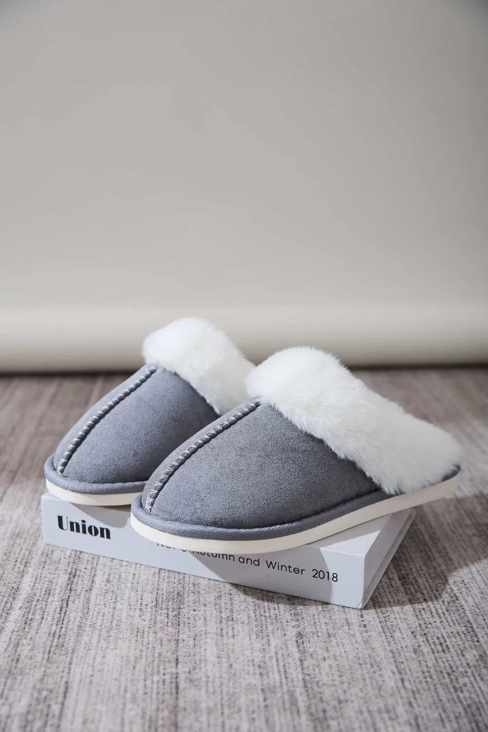 Dark Gray suede house slides with white shearling trim and contrast stitching.