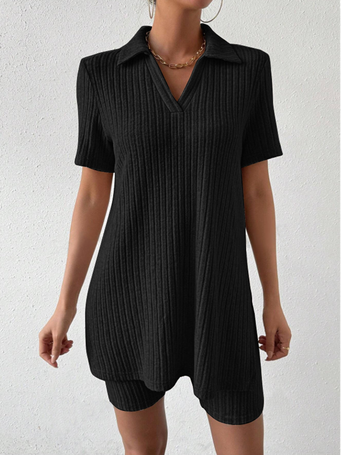 Black ribbed polo shirt and shorts set with a v-neck and collar detail.