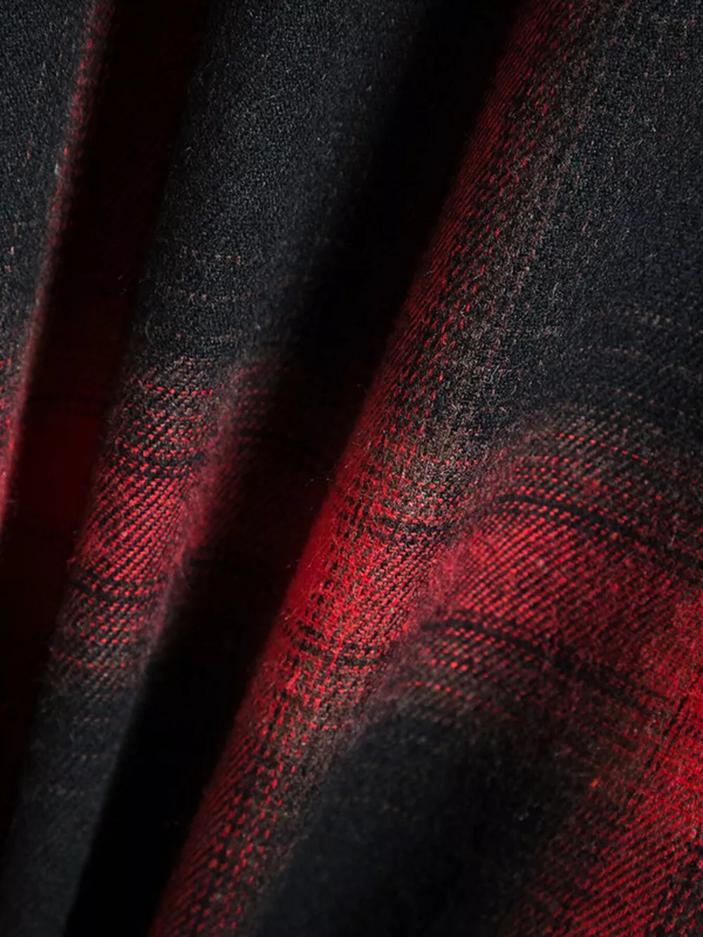 Classic plaid short-sleeve men's shirt in black and red cotton fabric.