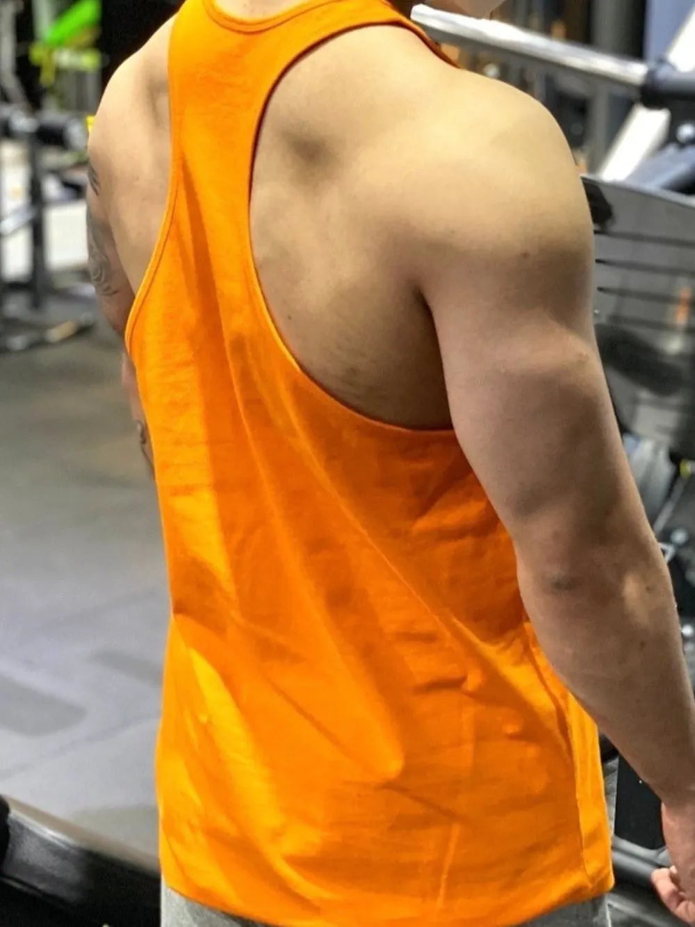 Tangerine performance racerback tank top with graphic detail, athletic fit