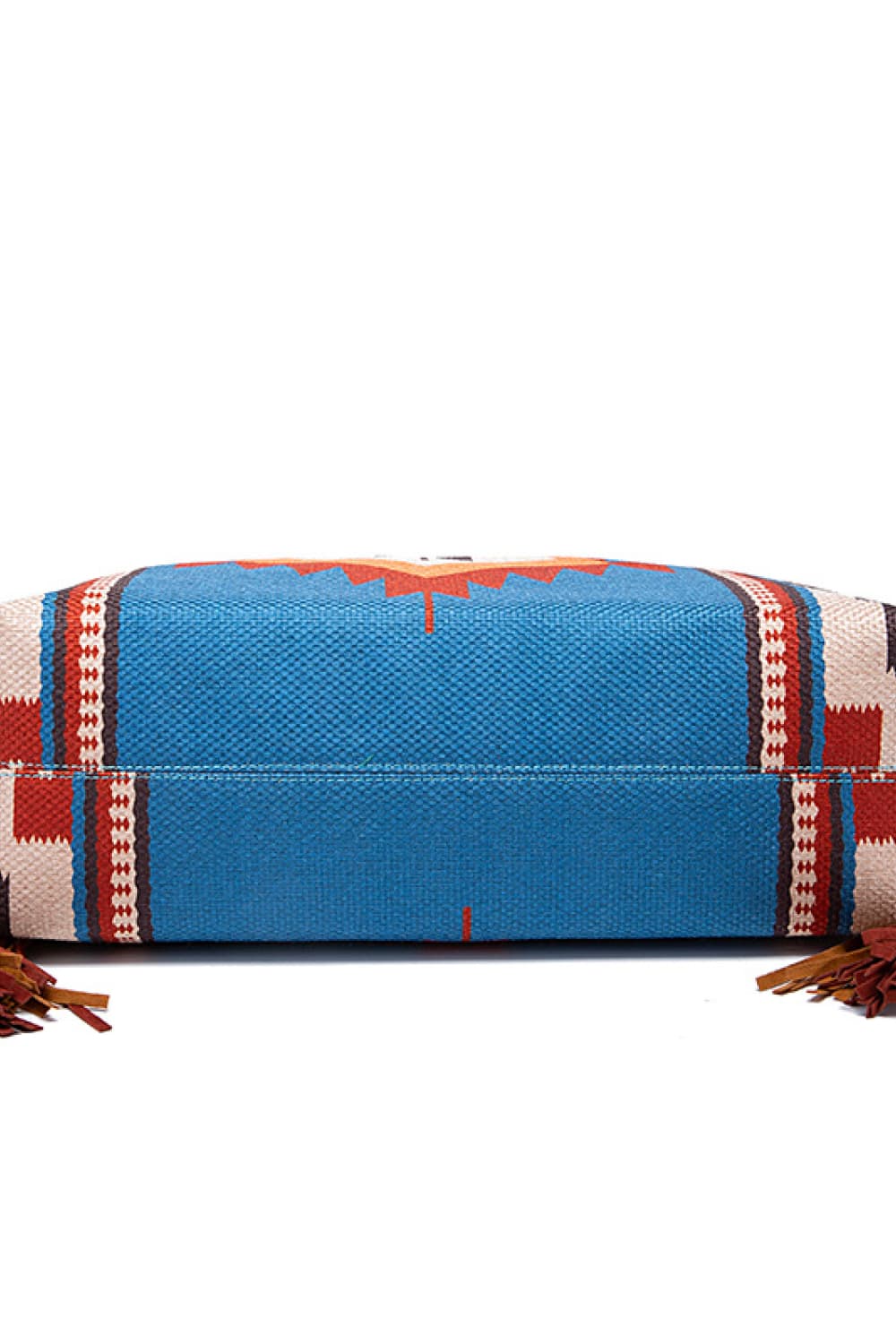 Southwestern fringe hobo bag in blue canvas with geometric pattern and leather fringe details.