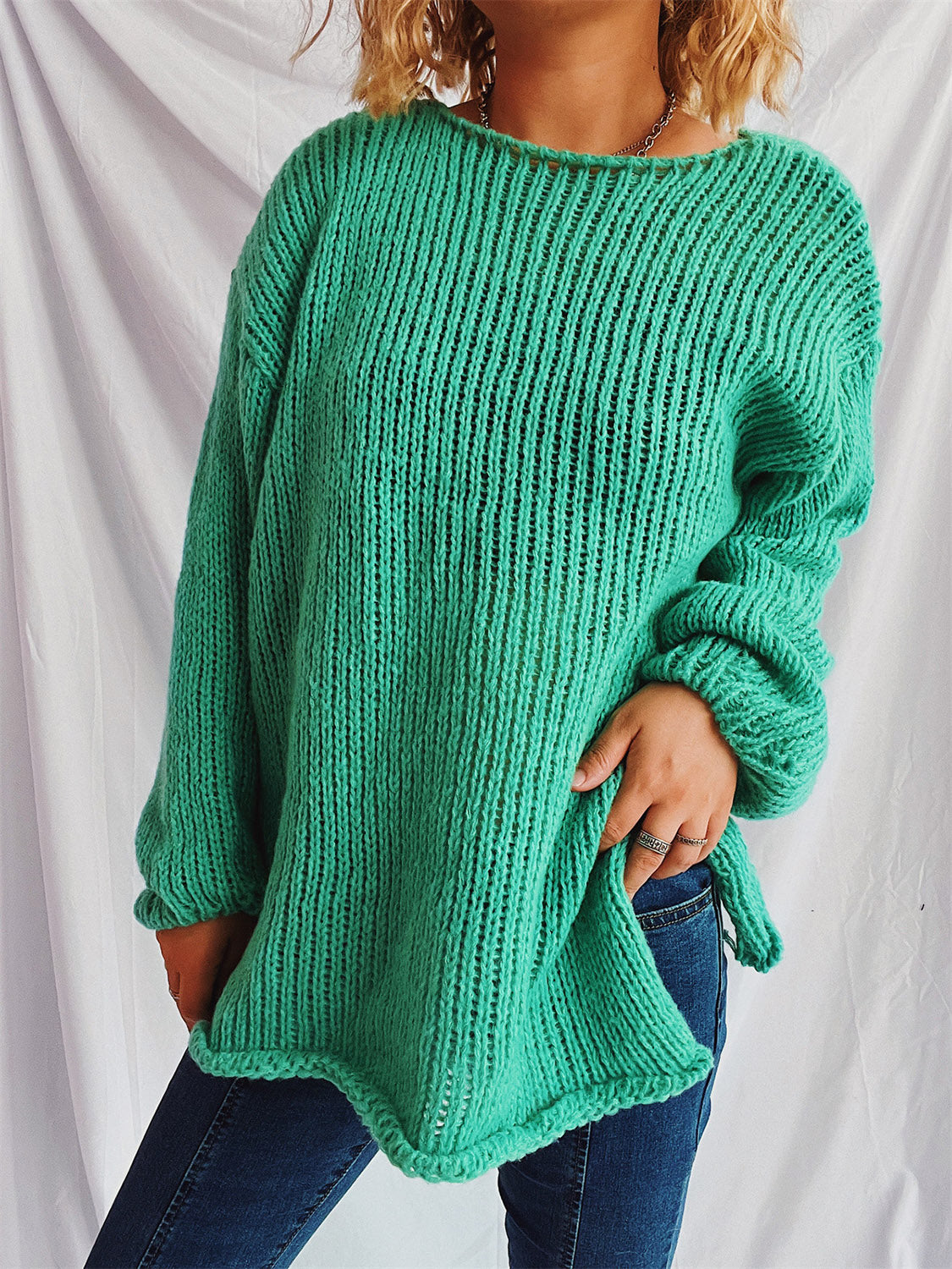 Turquoise open-knit acrylic slouchy boatneck pullover sweater with long sleeves.