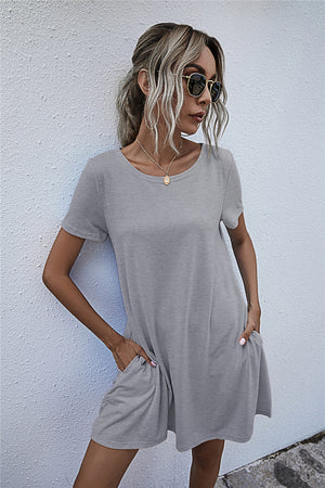 Light gray relaxed tee dress with short sleeves and side pockets.