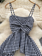 Black and white gingham cami top with twisted knot detail and asymmetrical hem.