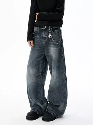 Belted wide-leg jeans in dark wash cotton with unique paneled design and chain detail.