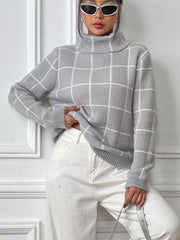 Gray grid-patterned turtleneck knit pullover sweater with long sleeves.