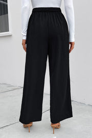 Black high-waist tie palazzo trousers with a relaxed fit and wide leg.